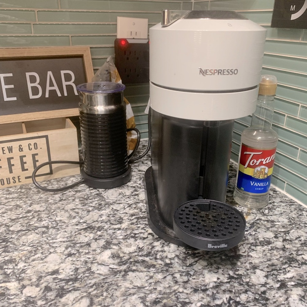 Nespresso + frother with pod holder and sign